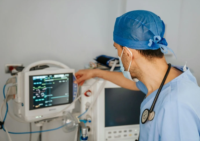 Worker checking medical monitoring equipment