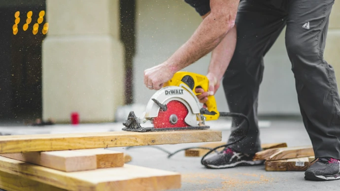 Person using a circular saw to cut wood